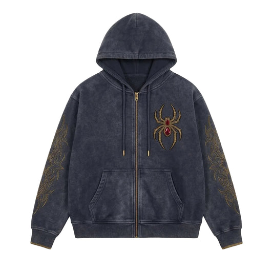 A dark gray zip-up hoodie with a washed texture, featuring a gold spider graphic with a red jewel on the chest and gold sleeve patterns, displayed against a neutral gray background.