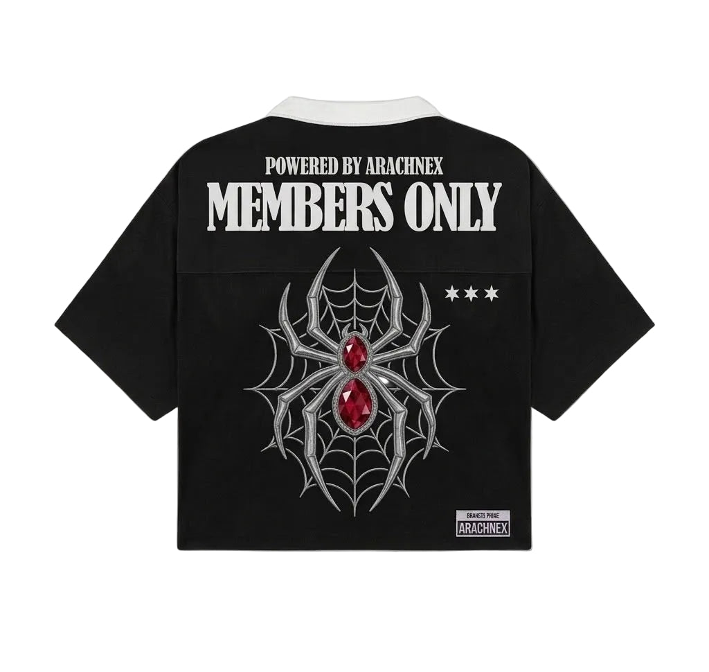 Black short-sleeve cropped shirt with a white collar, featuring a large silver spiderweb and red gem graphic on the back, with white text reading 'POWERED BY ARACHNEX MEMBERS ONLY' and a small Arachnex label near the hem.