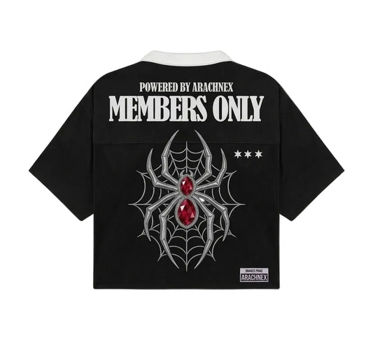 Black short-sleeve cropped shirt with a white collar, featuring a large silver spiderweb and red gem graphic on the back, with white text reading 'POWERED BY ARACHNEX MEMBERS ONLY' and a small Arachnex label near the hem.
